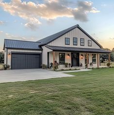 a large house with a metal roof and two garages