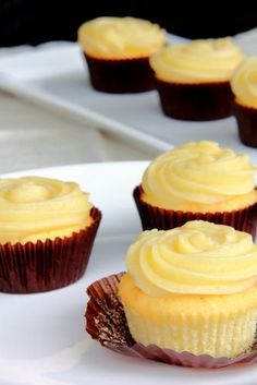 some cupcakes are sitting on a white plate