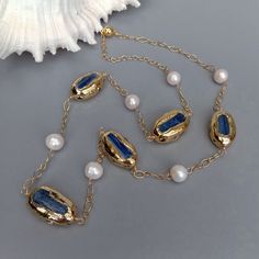 Gems Info: freshwater cultured pearl, white potato pearl, natural blue kyanite and tourmaline rough with gold plated edge. Diameter: 19x32mm(kyanite), 13mm(white pearl) Length: 33" / 83.82cm weight:  82 gram Clasp: 18 K GP magnet clasp Packing: pouch On Oct 30, 2022 at 20:06:10 PDT, seller added the following information: Jewelry Design Inspiration, Blue Kyanite, Station Necklace, Fashion Jewelry Necklaces, Pearl White, Pearl Jewelry, Fashion Watches, Tourmaline, Jewelry Watches