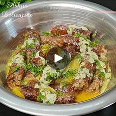 a metal bowl filled with food on top of a table