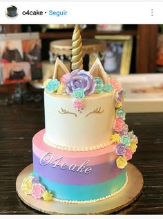 there is a cake decorated with flowers and a unicorn on top