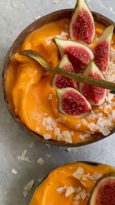 two bowls filled with fruit and topped with cheese