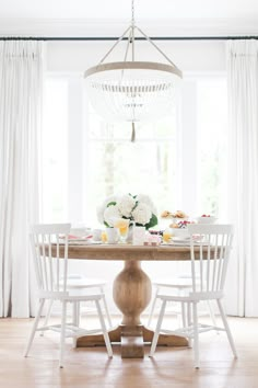 the instagram page on instagram shows an image of a table with white chairs and flowers