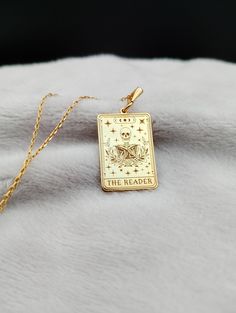 Introducing our enchanting Reader Tarot Card Necklace, a mesmerizing fusion of mystical allure and literary charm. Crafted with delicate precision in 14K gold, this dainty yet captivating piece features an intricately designed skeleton holding a cherished book, symbolizing the timeless bond between knowledge and the supernatural. Perfect for the bookworm in your life, this handmade treasure is not just a necklace, but a talisman of inspiration and imagination, making it an ideal gift for any devoted bibliophile or tarot enthusiast seeking to adorn themselves with the essence of wisdom and wonder. ⭐ Package included: One Handmade Necklace ⭐ Pendant Sizes: 18 / 20 / 22 / 24 / 26 / 28 / 30 mm ⭐ Necklace Length: 14 / 16 / 18 / 20 / 22 inches ⭐ Materials: 925 Sterling Silver / Gold Plated / 14K The Reader Tarot Card, Tarot Card Necklace, Gold Skeleton, Skeleton Necklace, Lover Necklace, Spiritual Necklace, Card Necklace, Book Necklace, Talisman Necklace