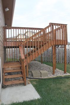 there is a wooden stair case in the yard