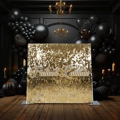 a black and gold party backdrop with balloons