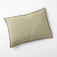 a beige pillow on a white background