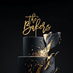 a black and gold cake with the words the bakers on top