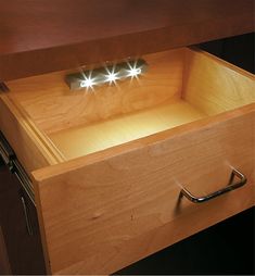 an open drawer with two lights in it and the words led schubladenicht