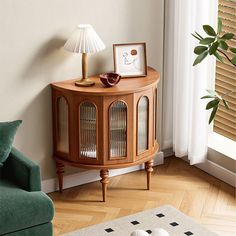 a living room with a green chair and a small birdcage on the floor