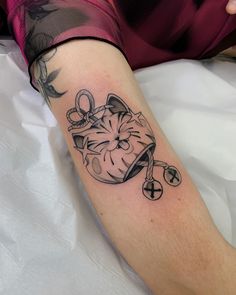 a tattoo on the arm of a woman with scissors and a clock in her hand