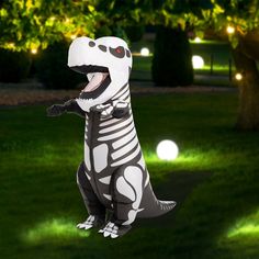 an inflatable dinosaur is standing on its hind legs and has it's mouth open