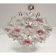 a chandelier with pink and white flowers hanging from it's center point