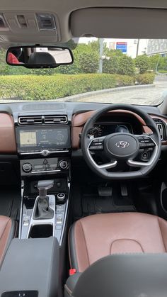 the interior of a car with brown leather seats and dash board, steering wheel and dashboard