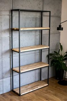 an empty shelf in the corner of a room with a potted plant on it