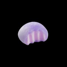 a purple jellyfish floating in the dark water