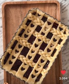 a heart shaped pie sitting on top of a wooden tray