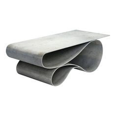 two concrete tubes stacked on top of each other in front of a white background,