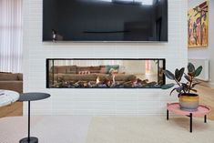 a television mounted above a fireplace in a living room