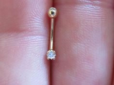 a close up of a person's finger with a diamond ring on top of it