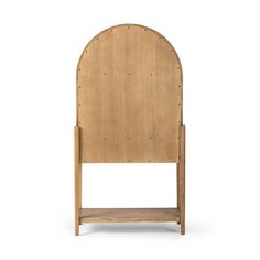 a wooden chair with an arch shaped back and foot board on the side, against a white background