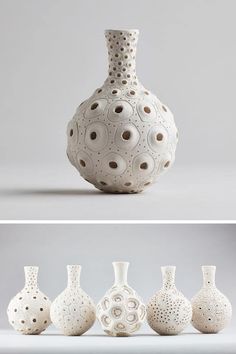 four white vases sitting next to each other