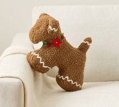 a stuffed dog sitting on top of a white couch