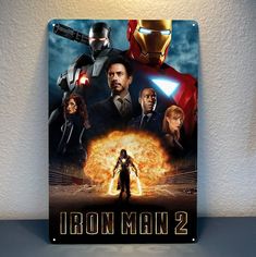 the poster for iron man 2 is displayed on a wall