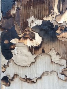 an old piece of wood that has been peeling and chipped with paint on it