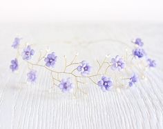 a purple flower headpiece on a white table