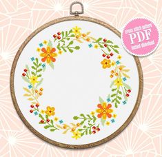 a cross stitch hoop with flowers on it