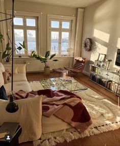 a living room filled with furniture and lots of windows