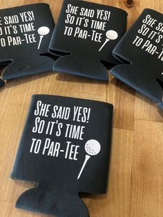 four black can coolers with funny sayings on them sitting on a wooden table