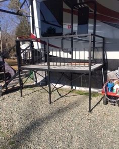 an rv is parked on the side of the road with its ladder up to it's roof