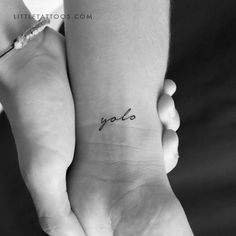 two people holding each other's hands with the word golo tattooed on their wrist