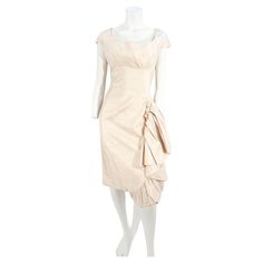 1950s "Mignon" Cream colored silk sheath dress featuring a boat neckline, short cap sleeves, a fitted bodice. The bust-line down is constructed of matching in-set strips of silk The skirt features a large asymmetrical wide ruffle up to the hipline and finished with decorative matching fashion buttons. The back has a zipper closure and this dress is fully lined in cotton around the bust-line and rayon crape below. 40 inch bust 30 inch waist 38 inch hip 42 inch length Silk Sheath Dress, Color Crema, Cream Silk, Boat Neckline, Fitted Bodice, Sheath Dress, Cream Color, Cap Sleeves, Bodice