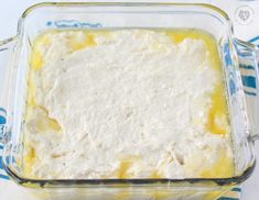 an uncooked casserole in a glass dish on a blue and white towel