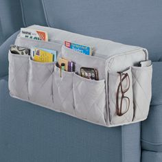 Protect the arms of your furniture and add valuable storage space with this clever armrest cover. The quilted cover includes 4 pockets on both the inner and outer panels, plus 2 more pockets on the front to hold remote controls, reading materials, phones, glasses and more. The durable cover is available in 3 versatile colors and is machine washable. Polyester; imported. Measures 19 1/2"L x 6"W x 8 1/2"H. Choose: Burgundy, Grey or Chocolate. Rebrilliant Color: Gray | Rebrilliant Slipcover 9.1 H x Bedside Caddy, Sofa Armrest, Remote Control Holder, Remote Holder, Clean Sofa, Hanging Closet, Bedside Storage, Tv Remote Controls, Chair Storage