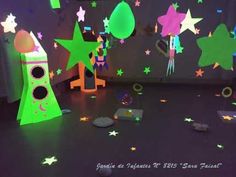 a room filled with lots of green and purple stars on the wall next to a speaker