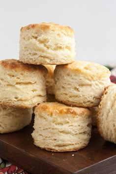 a pile of biscuits sitting on top of a wooden cutting board