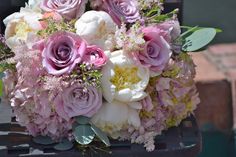 a bouquet of flowers sitting on top of a chair