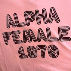 a pink shirt with black letters that read, alphabet female 1970