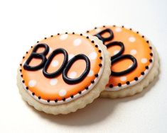 two decorated cookies with the word boo on them