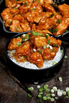 two black bowls filled with chicken and rice