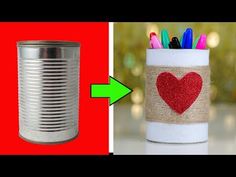 two tin cans with pens and markers in them, one has a heart painted on it