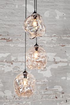 three clear glass globe lights hanging from the ceiling