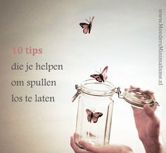 a person holding a jar with butterflies in it and a quote on the wall behind it