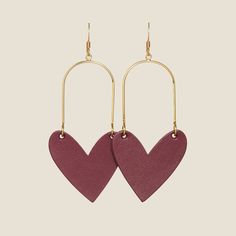 Our Burgundy Sweethearts feature a matte deep red leather with a smooth satin finish. These lightweight statement earrings feature our signature heart shape and the option of gold or silver hoop hardware. Model is WearingBurgundy Sweethearts in GoldGold Bar StudsClassic Crystal Studs Nickel And Suede, Heart Shaped Pendant Necklace, Mini Studs, Heart Shaped Necklace, Bold Accessories, Bar Studs, Heart Shaped Earrings, Heart Shape Pendant, Leather Pieces