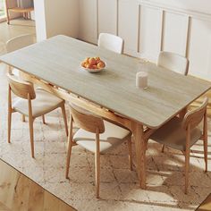 a dining room table with chairs and fruit on the plate next to it, in front of a white paneled wall