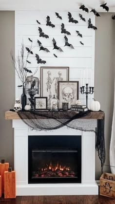 a fireplace decorated with halloween decorations and bats